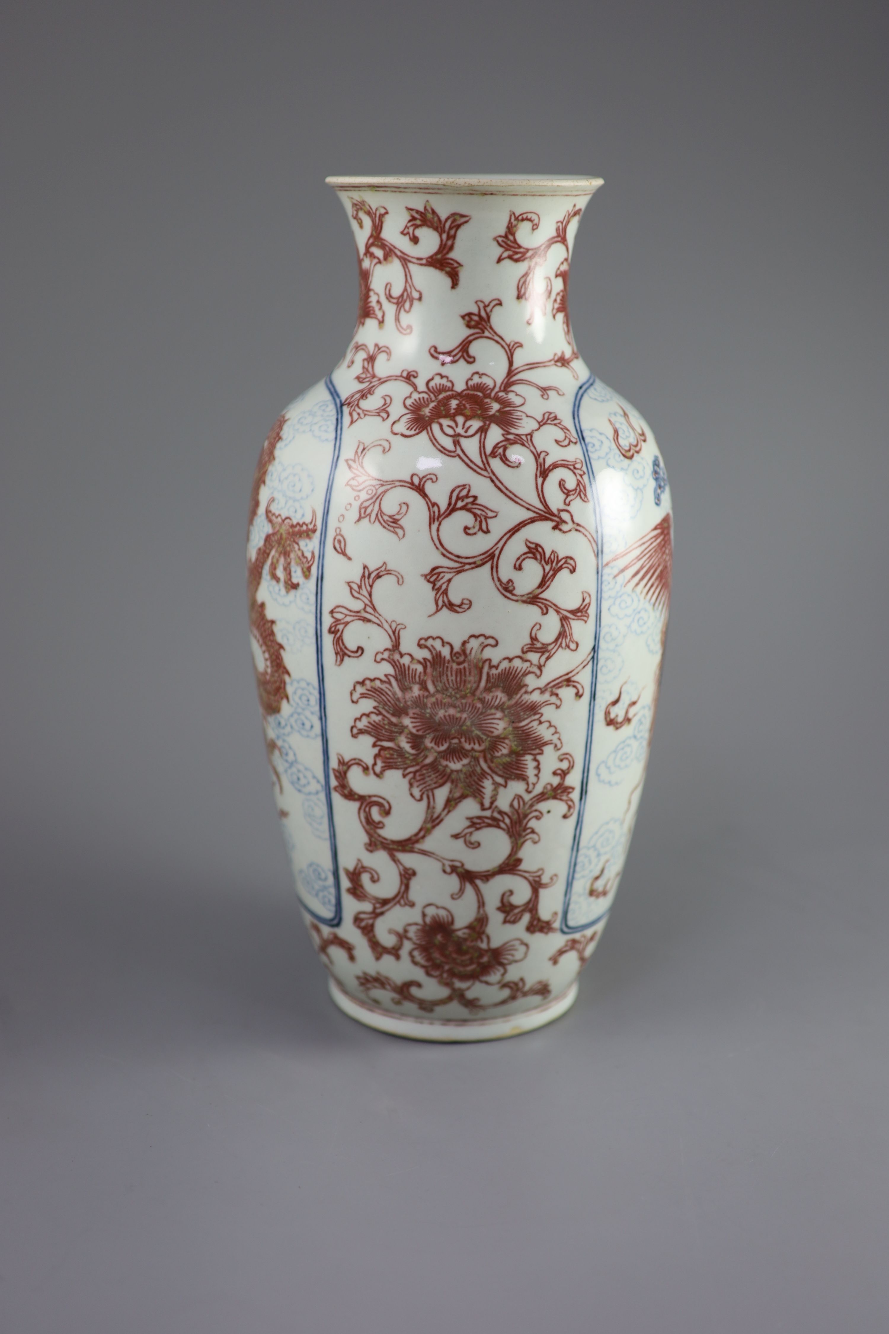 A Chinese underglaze blue and copper red 'dragon and phoenix' vase, Daoguang period (1821-50), 36cm high, rim ground off